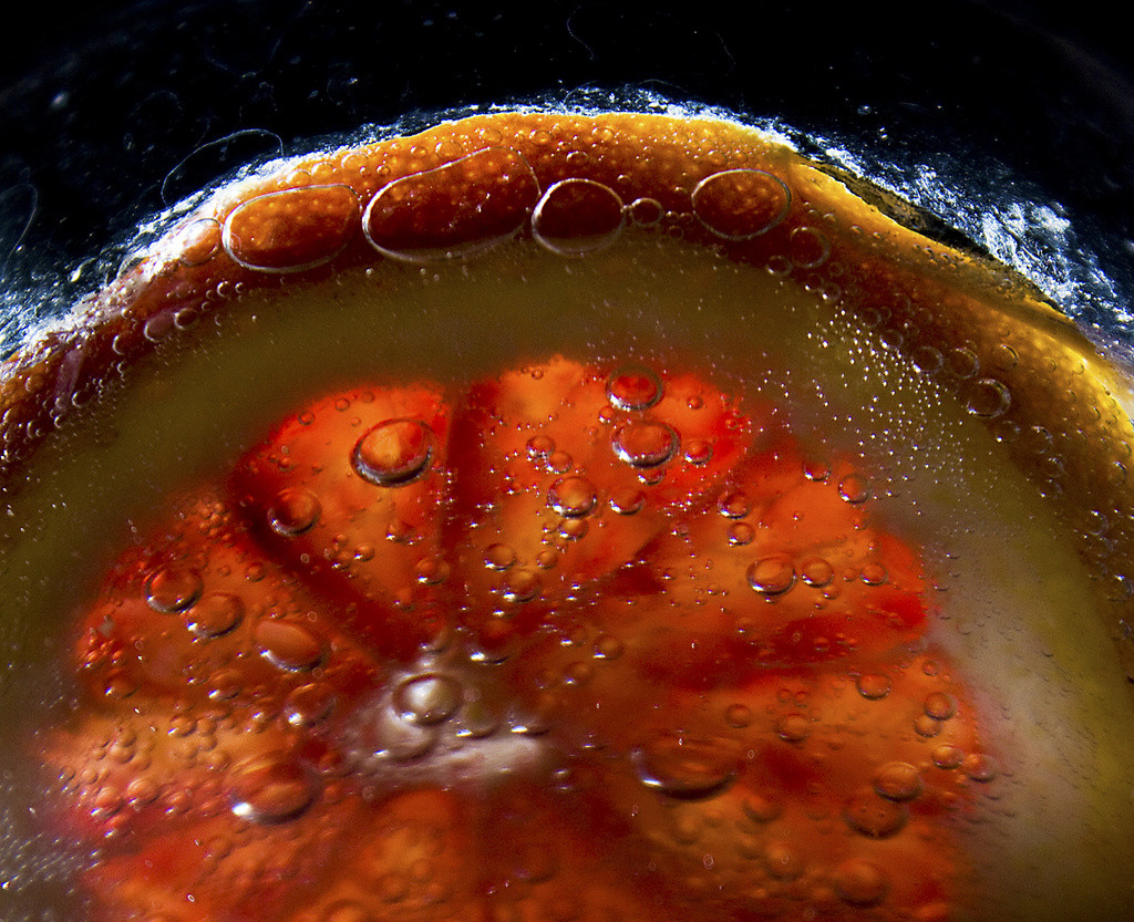 A slice of blood orange submerged in water
