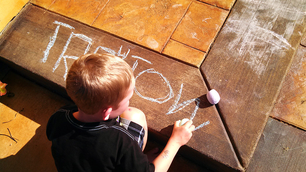 Trey writing his name with chalk