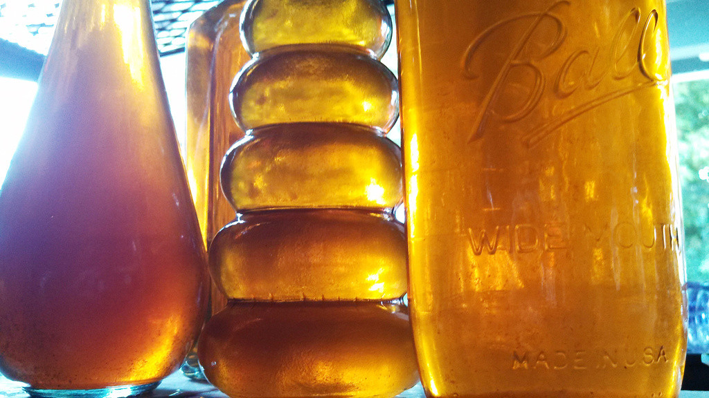 Bottles of homemade pear vodka backlit