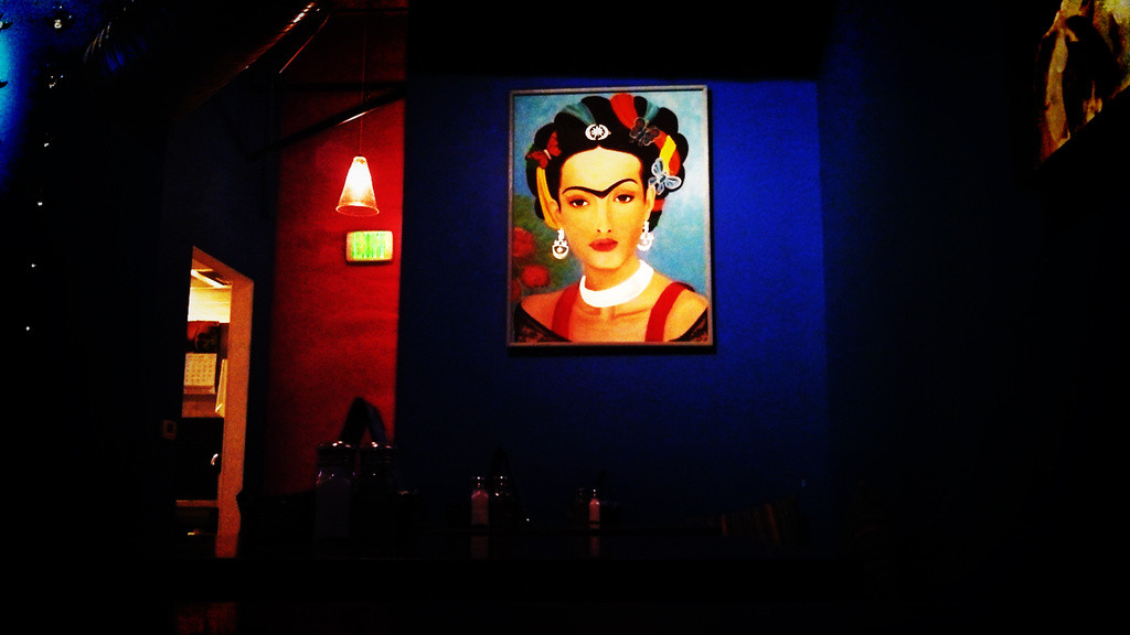 A painting reminiscent of Frida Kahlo on the wall of Azul Tequila bar