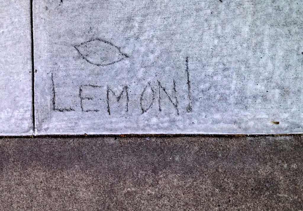 Lemon! scratched into cement sidewalk
