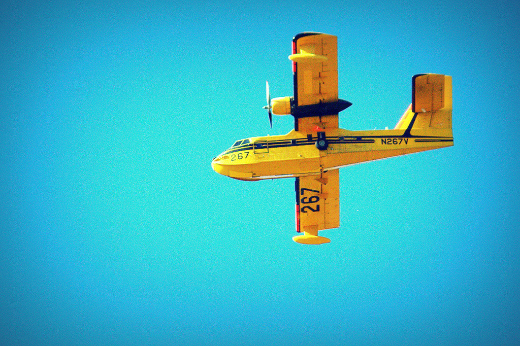 Yellow airplane against a blue sky