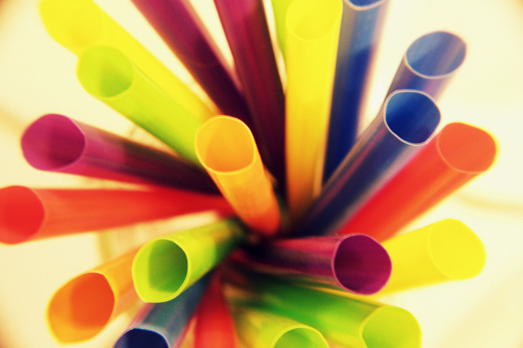 Colorful straws in a cup shot from above