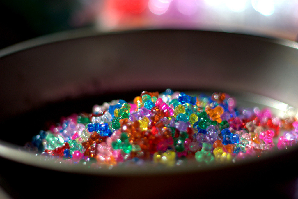 Colorful plastic beads in a tin pan